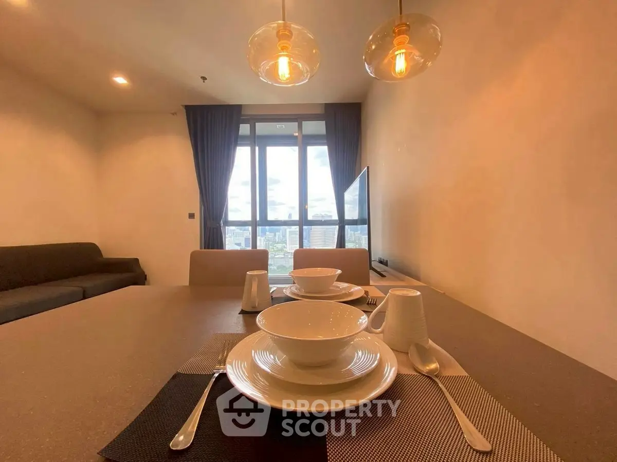 Modern dining area with stylish lighting and city view