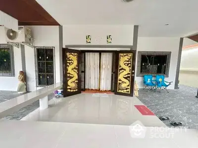 Spacious modern entrance with dragon-themed doors and elegant flooring