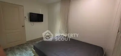 Cozy bedroom with wall-mounted TV and minimalist decor