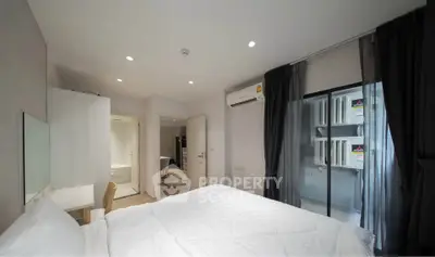 Modern bedroom with balcony access and sleek design