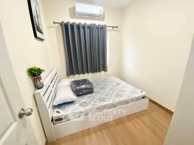 Cozy bedroom with modern decor and air conditioning, perfect for restful nights.