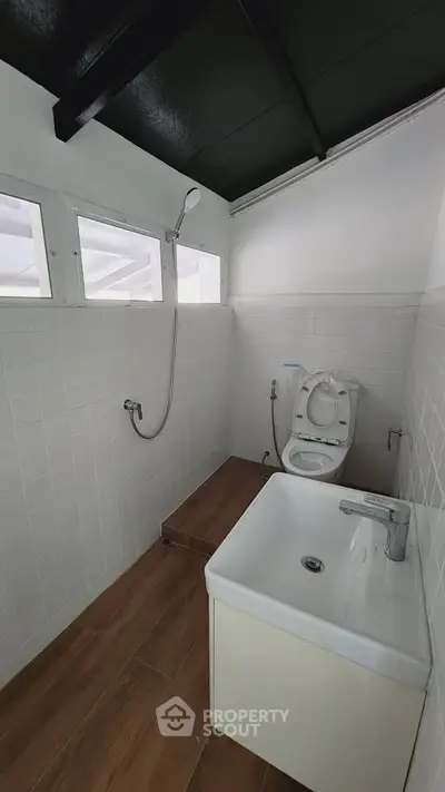 Modern minimalist bathroom with sleek fixtures and natural light