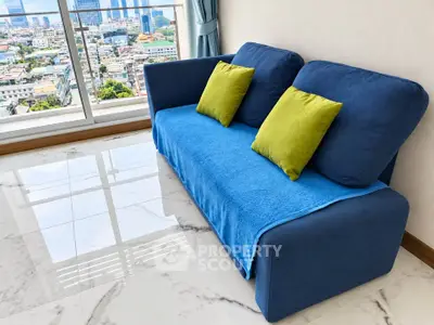 Modern living room with blue sofa and city view from large window