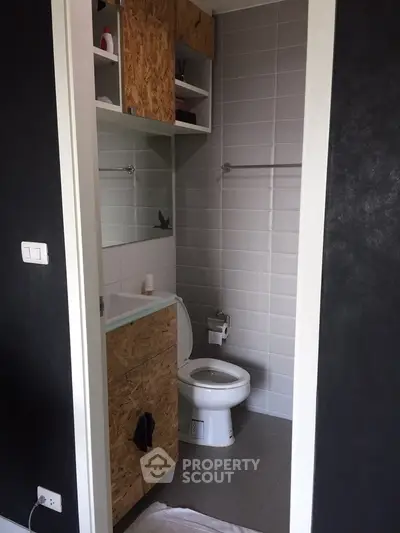 Compact modern bathroom with minimalist design and wooden accents