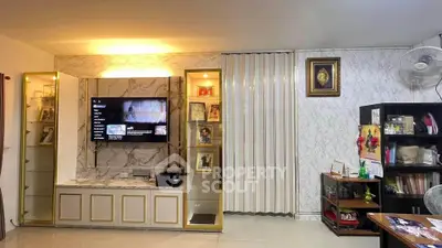 Elegant living room with marble accents and modern entertainment center