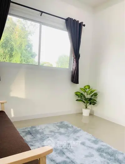 Bright and airy living room with large window and cozy decor