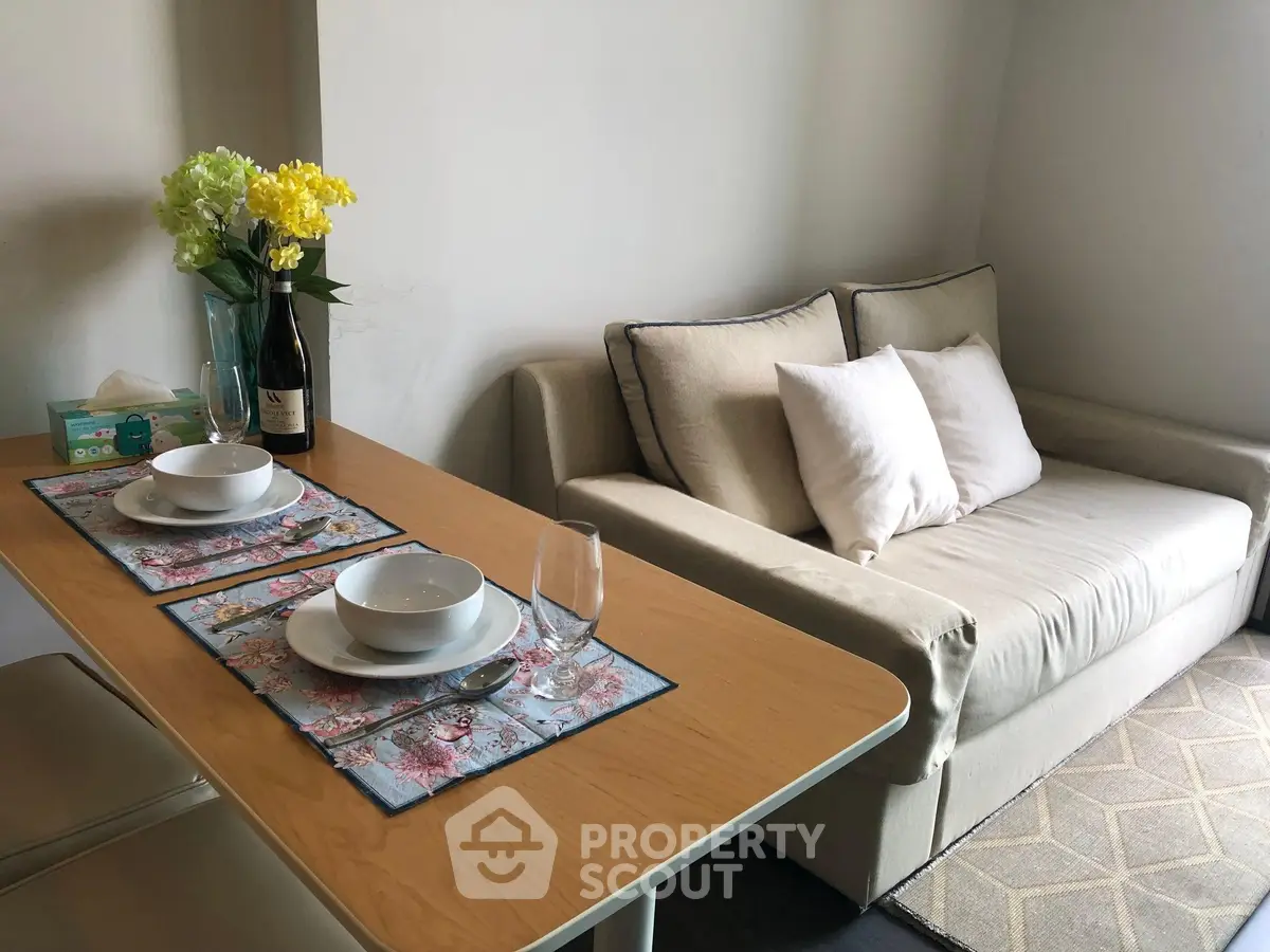 Cozy living room with elegant dining setup and comfortable sofa, perfect for modern living.