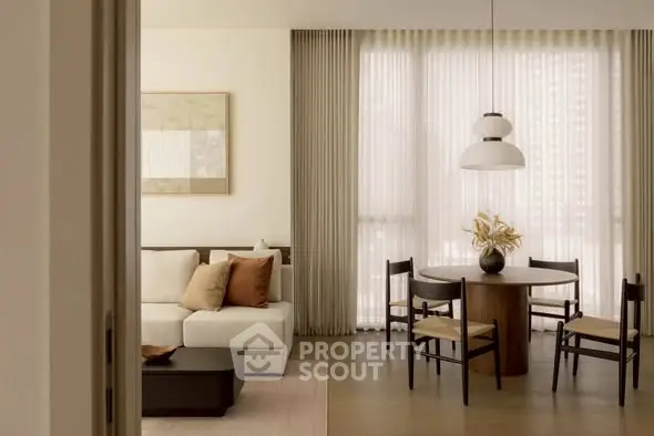 Elegant living room with modern dining area, featuring stylish furniture and soft lighting.
