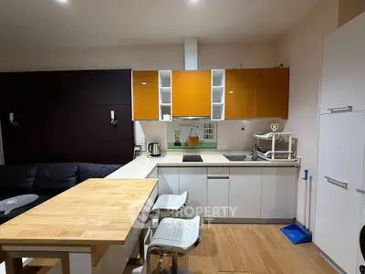 Modern kitchen with open layout and stylish orange cabinets
