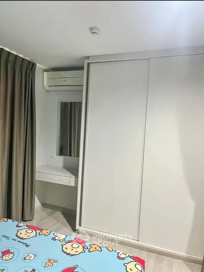 Cozy bedroom with built-in wardrobe and air conditioning, perfect for comfortable living.