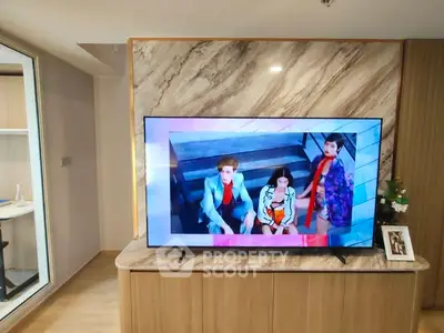 Modern living room with large TV and stylish decor