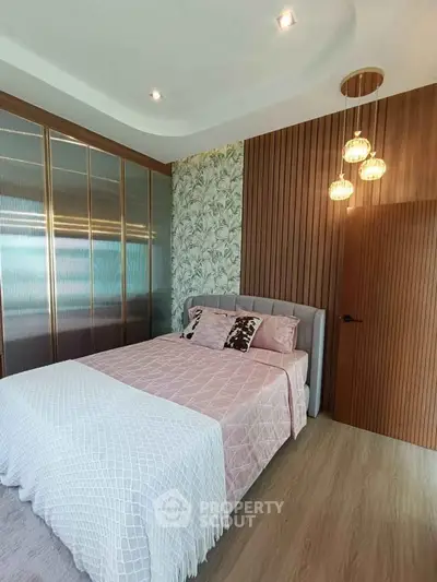 Stylish bedroom with modern decor, featuring a cozy bed, elegant lighting, and chic wall design.