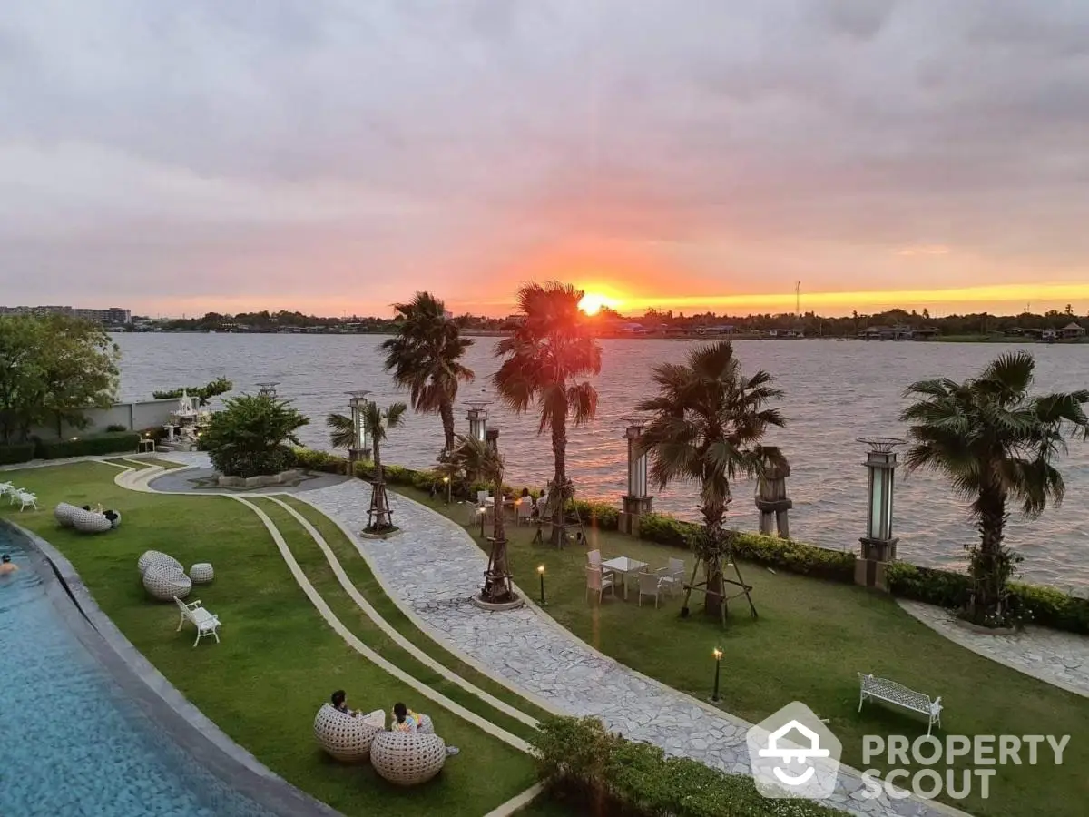 Stunning riverside view with lush garden and sunset, perfect for luxury living.