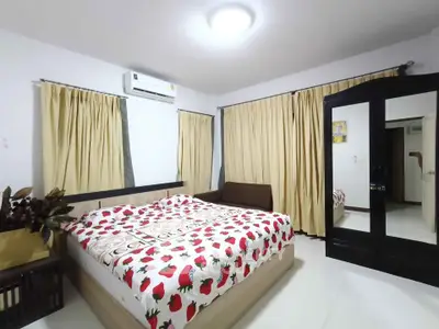 Spacious bedroom with modern decor and ample natural light