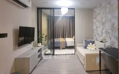 Modern living room with stylish decor and sliding glass doors leading to a cozy bedroom.