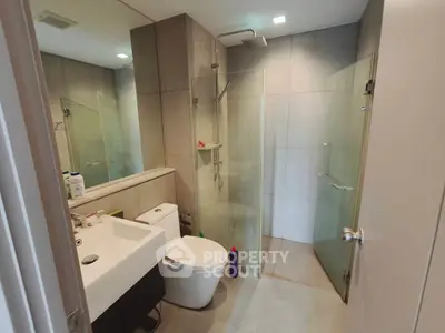Modern bathroom with glass shower and sleek fixtures