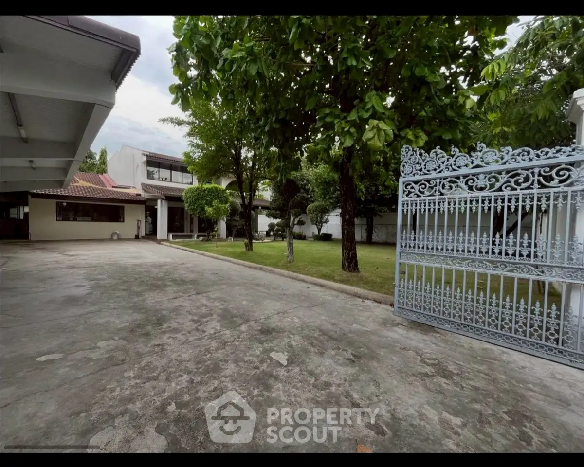 Spacious property with lush garden and elegant gated entrance, perfect for serene living.