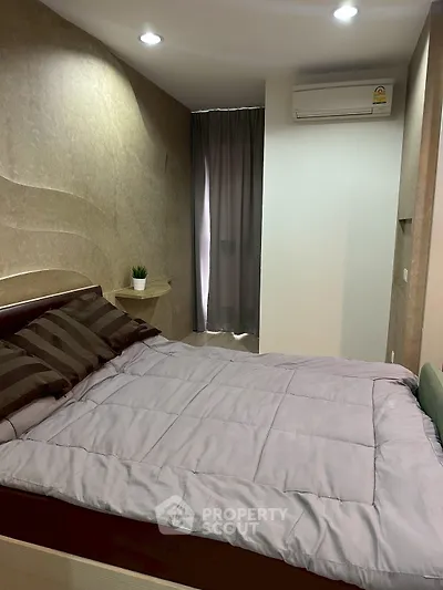 Cozy bedroom with modern decor and air conditioning, perfect for restful nights.