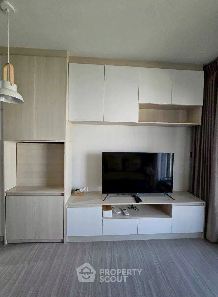 Modern living room with sleek TV unit and ample storage space