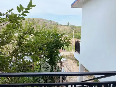 Charming balcony view with lush greenery and serene landscape