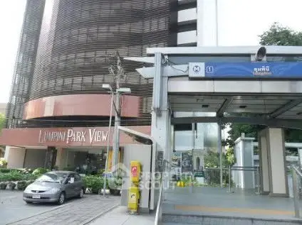 Modern building exterior with nearby metro entrance, ideal urban living location.