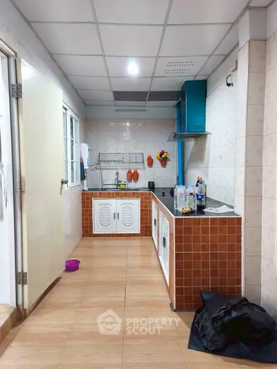 Charming kitchen with closed layout and modern appliances, perfect for culinary enthusiasts.