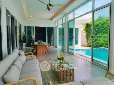 Luxurious living room with pool view and modern furnishings