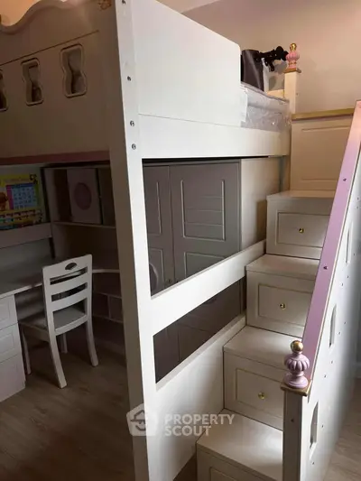 Charming children's bedroom with loft bed and study area, perfect for maximizing space and functionality.