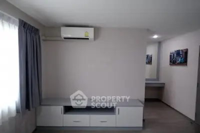 Modern living room with air conditioning and sleek furniture