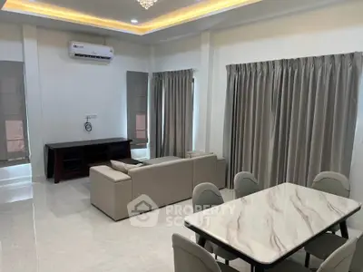 Spacious living room with modern furniture and elegant dining area