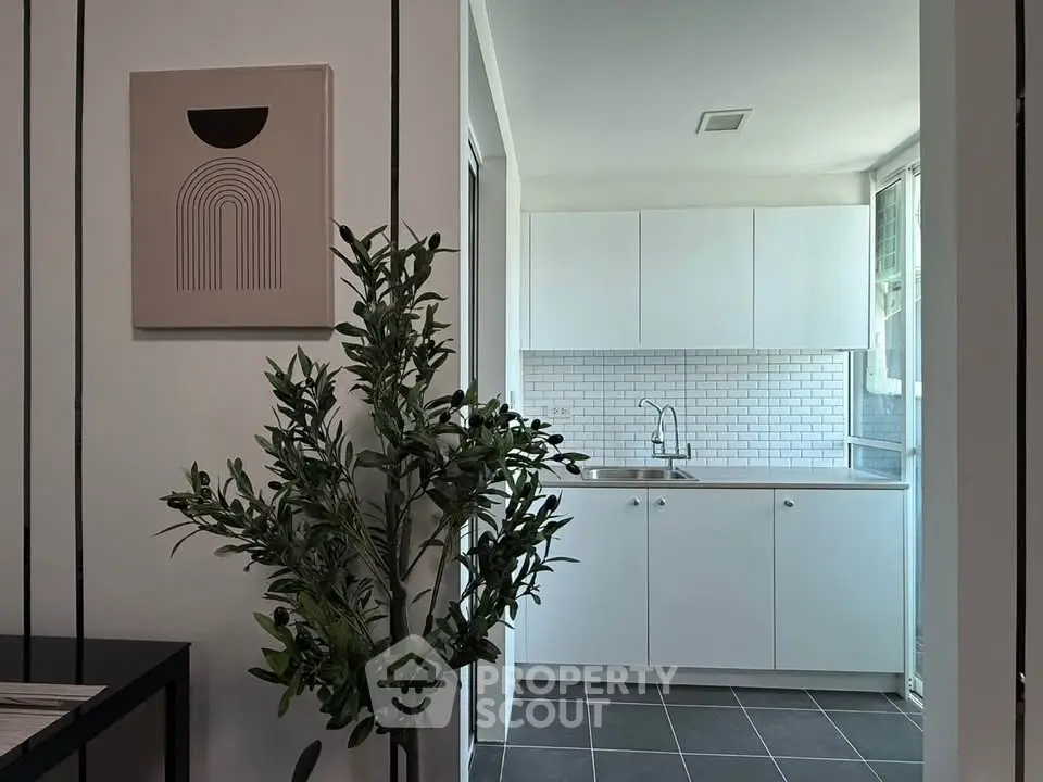 Modern kitchen with sleek white cabinets and stylish backsplash