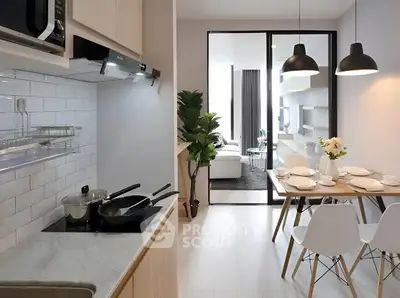 Modern open-layout kitchen and dining area with sleek design and natural light.