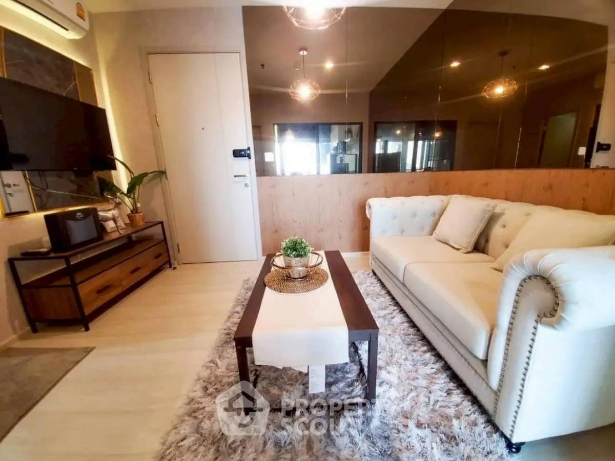 Stylish living room with plush sofa and modern decor in a cozy apartment setting.