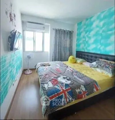 Cozy bedroom with vibrant decor and natural light, featuring a comfortable bed and modern furnishings.