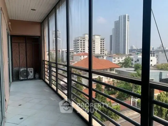 Spacious balcony with city view in modern apartment building