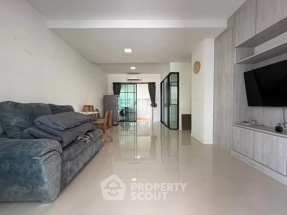 Spacious living room with modern decor and large windows for natural light.