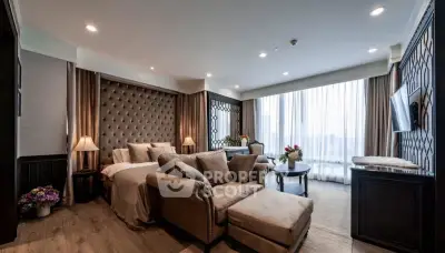 Luxurious living room with elegant decor and large windows offering natural light.
