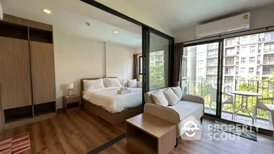 Modern studio apartment with cozy bedroom and balcony view