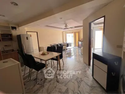 Spacious open-plan living and dining area with modern kitchen and ample natural light.