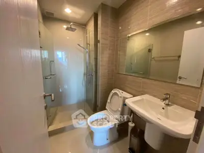 Modern bathroom with glass shower and sleek fixtures in a contemporary apartment.