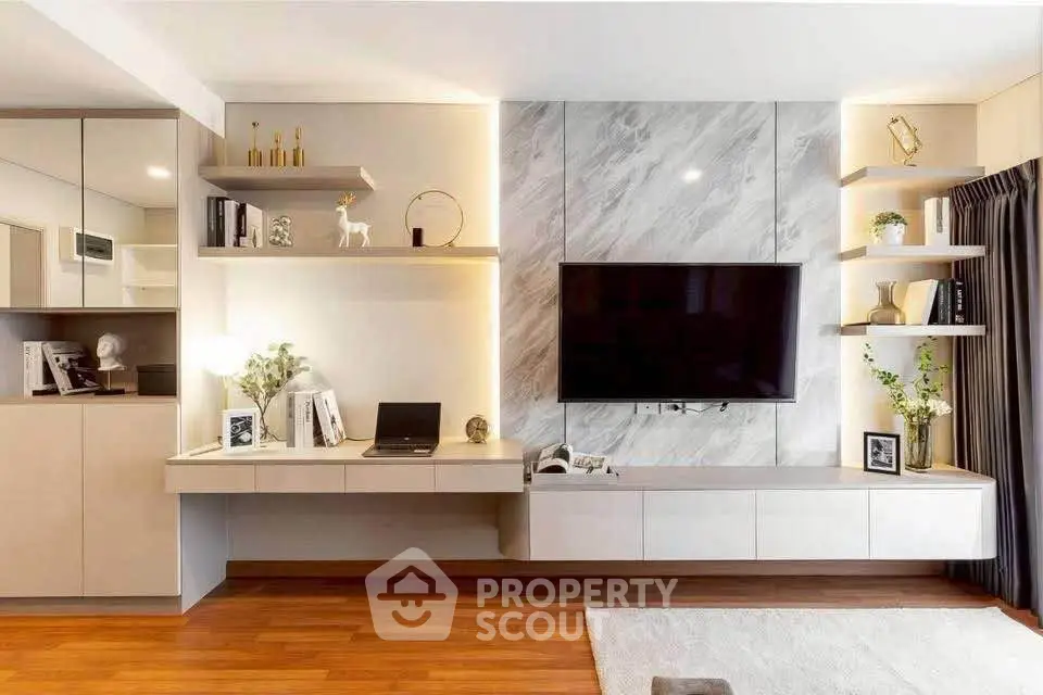 Modern living room with sleek design, built-in shelves, and mounted TV on marble accent wall.