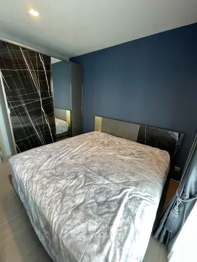 Modern bedroom with stylish blue accent wall and sleek wardrobe design