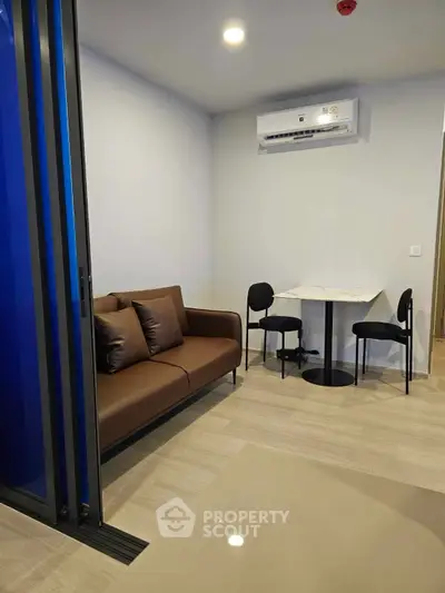 Modern living room with sleek furniture and air conditioning, perfect for cozy urban living.