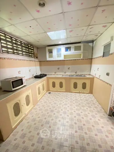 Spacious kitchen with closed layout and modern appliances in a cozy home.