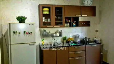 Cozy kitchen with brown cabinets and modern appliances, perfect for culinary enthusiasts.