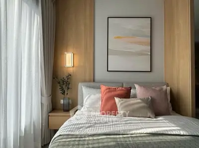 Cozy bedroom with modern decor, featuring a stylish bed, soft lighting, and elegant wall art.