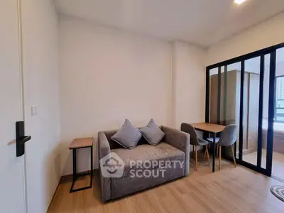 Modern living room with cozy sofa and dining area in open-plan apartment
