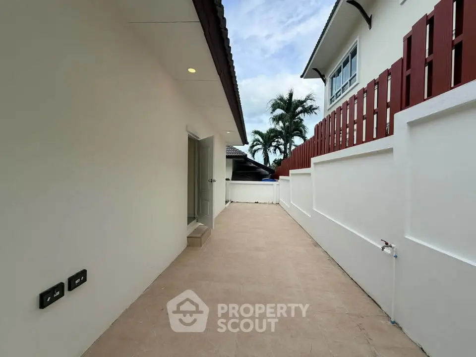 Spacious outdoor area with tiled flooring and modern design in a residential property.