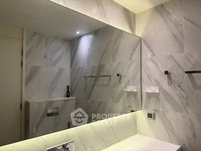 Luxurious modern bathroom with marble walls and large mirror