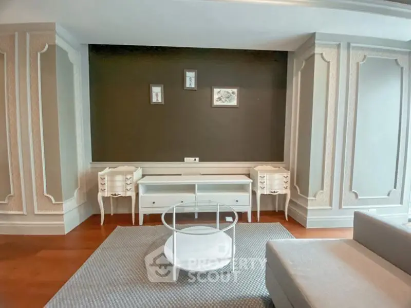Elegant living room with classic wall paneling and modern furniture
